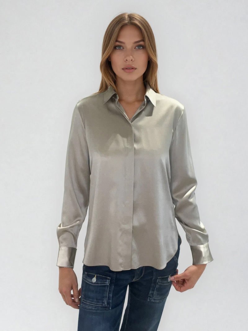 Chemise manches longues coloris taupe en soie. Coupe légèrement cintrée avec 2 pinces dans le dos. Patte de boutonnage recouverte.  Vue face.