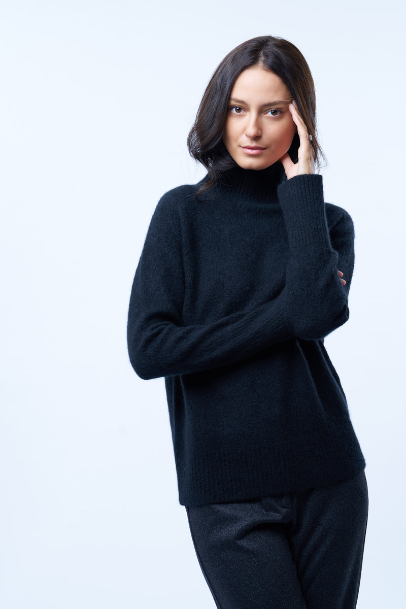 Pull manches longues col roulé JANE coloris noir en cachemire et soie, très doux. Le col est haut et souple, ne serre pas. Coupe droite, emmanchures raglan, finitions côtes.