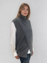 Pull sans manches anthracite  avec un col montant et une ouverture en diagonale sur le devant formant un croisé. A porter avec un chemisier en dessous. Coupe droite et longue.  42% cachemire, 8% soie, 50% mérinos. Vue profil.